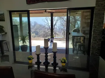 a dining room with a table with candles on it at Matanah Meadows Farm, Great for 2 Families, Sequoia National Park and Working Farm in Three Rivers