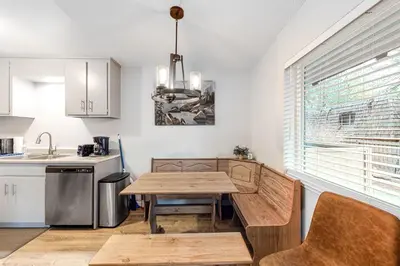 a kitchen with a wooden table and a dining room at North Tahoe Nest in Incline Village