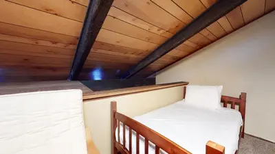 a bed in a room with a wooden ceiling at Horizons 4 #186 condo in Mammoth Lakes