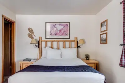 a bedroom with a bed and two tables with lamps at Franciscan Lodge in Tahoe Vista