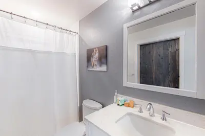 a bathroom with a sink and a toilet and a mirror at Starfall in Yosemite West