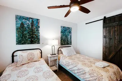 a bedroom with two beds and a ceiling fan at Starfall in Yosemite West