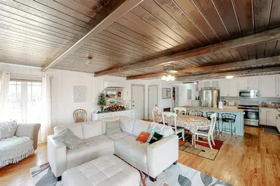 a living room with a white couch and a table at Bear Den in Oakhurst