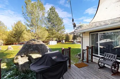 a trash can sitting on a deck next to a house at Bear Den in Oakhurst