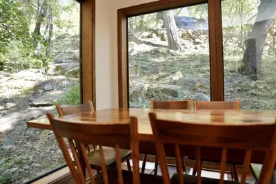 a wooden table and chairs in front of a window at Forest Glen in Yosemite West