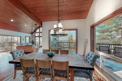 a dining room with a wooden table and chairs at Glacier Peak Lodge in Yosemite West