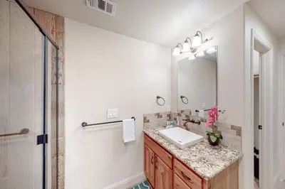 a bathroom with a sink and a mirror at Glacier Peak Lodge in Yosemite West