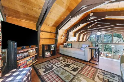 a living room with a couch and a tv at Chief Peak in Fish Camp