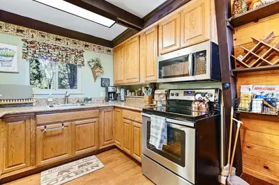a kitchen with wooden cabinets and a stove top oven at Chief Peak in Fish Camp