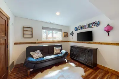 a living room with a leather couch and a television at A River Runs Through It in Incline Village