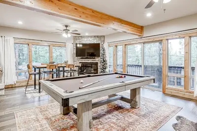 a pool table in a living room with windows at Susquehana Luxury in South Lake Tahoe