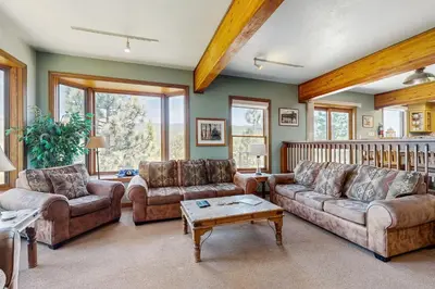 a living room with two couches and a table at Lookout Lodge in Zephyr Cove