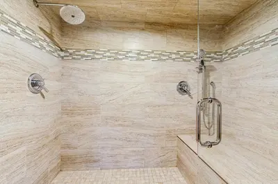 a bathroom with a shower with a stone wall at Lookout Lodge in Zephyr Cove