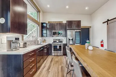 a large kitchen with a wooden counter top and a table at Bear's Den in Truckee