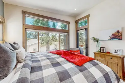 a bedroom with a bed and a large window at Bear's Den in Truckee