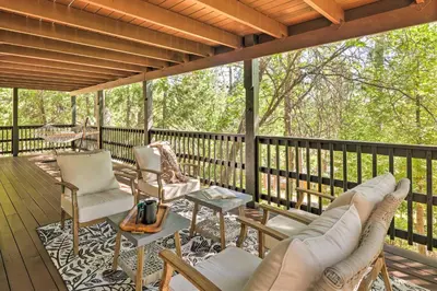 a screened in porch with chairs and a table at Near Trails Cabin with 2-Level Deck in Twain Harte in Twain Harte
