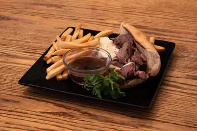 a plate of food with a sandwich and french fries at Genas's Sierra Inn & Restaurant in Dunlap