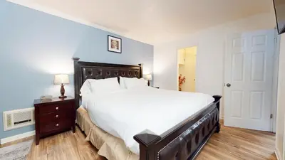 a bedroom with a large bed with a wooden headboard at Krystal Villas East #312 condo in Mammoth Lakes
