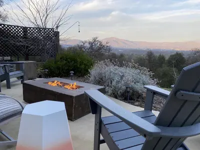 a patio with a fire pit and a chair and a table at Sierra Ranch - A Yosemite Retreat in Mariposa