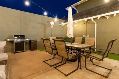 a patio with a table and chairs and a kitchen at Plush 2-bed apt in Riverside Heights! in Reno