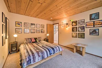 a bedroom with a bed and pictures on the walls at Deck and Fireplace Log Cabin in Tahoe Donner! in Truckee
