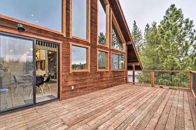 a house with a large deck with glass windows at Deck and Fireplace Log Cabin in Tahoe Donner! in Truckee