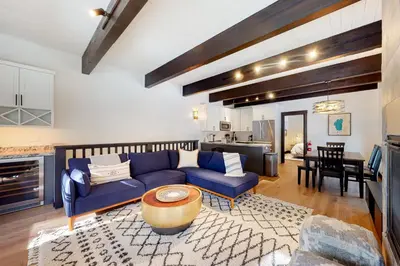 a living room with a blue couch and a table at Maison de Montagne in Incline Village