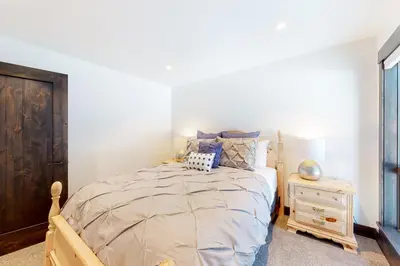 a bedroom with a wooden bed and a night stand at Maison de Montagne in Incline Village