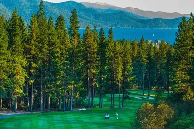 a golf course with trees and a view of a lake at Maison de Montagne in Incline Village