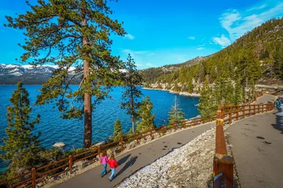 two people walking along the shore of a lake at Maison de Montagne in Incline Village