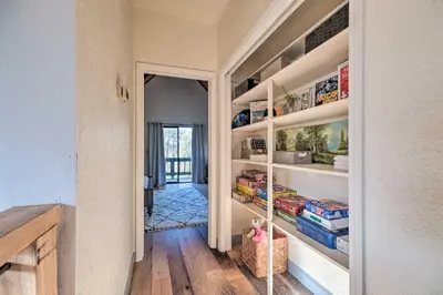 a walk in pantry with white shelves in a room at Modern Groveland Chalet about 25 Mi to Yosemite! in Groveland