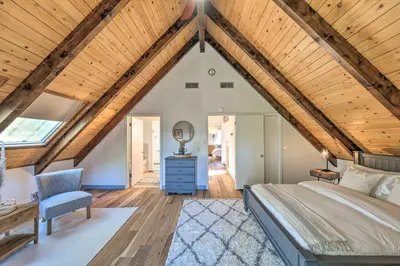 a bedroom with a large bed and a wooden ceiling at Modern Groveland Chalet about 25 Mi to Yosemite! in Groveland