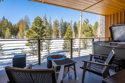 a screened in porch with chairs and a grill at Obsidian 300 in Mammoth Lakes