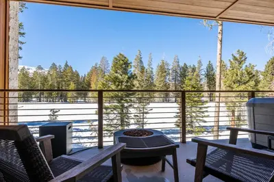 a screened in porch with a view of the woods at Obsidian 300 in Mammoth Lakes