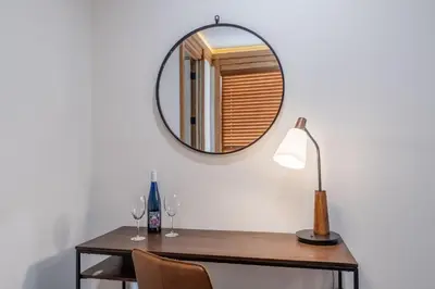 a mirror on a wall above a table with wine glasses at Obsidian 300 in Mammoth Lakes