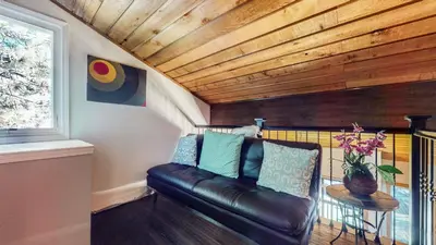 a living room with a leather couch and a table at Snowcreek I #28 condo in Mammoth Lakes