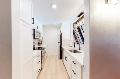 a kitchen with white cabinets and a sink at Kingswood Village 2 in Kings Beach