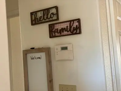 a bathroom door with two signs on the wall at WHOLE Family - Wholestyl in Sacramento