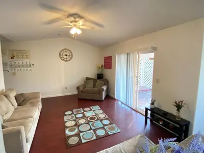 a living room with a couch and a ceiling fan at WHOLE Family - Wholestyl in Sacramento