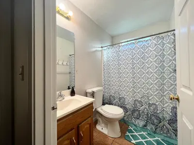 a bathroom with a toilet and a sink and a shower at WHOLE Family - Wholestyl in Sacramento