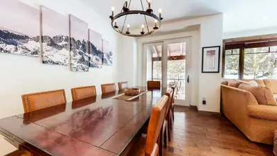 a dining room with a table and chairs and a couch at Woodwinds #1271 townhouse in Mammoth Lakes
