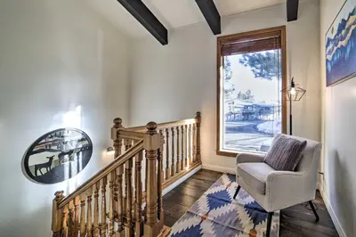 a stairway with a chair and a window at Epic Mammoth Lakes Getaway with Shared Pool, Hot Tub in Mammoth Lakes