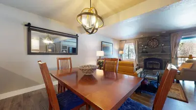 a dining room with a table and a fireplace at Mammoth Creek #9 condo in Mammoth Lakes