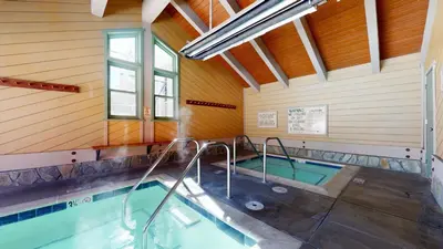 a swimming pool inside of a house with a swimming pool at Mammoth Creek #9 condo in Mammoth Lakes