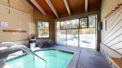 a swimming pool in a house with a window at Mammoth Creek #9 condo in Mammoth Lakes