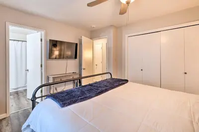 a large bedroom with a bed and a tv at Lakeside Groveland Home with Hot Tub, Near Yosemite in Groveland