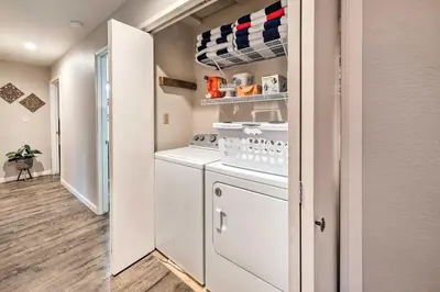 a kitchen with a washer and dryer in a room at Lakeside Groveland Home with Hot Tub, Near Yosemite in Groveland