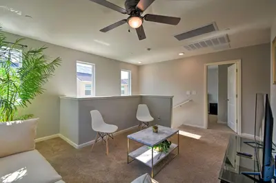a living room with a ceiling fan and a couch at 4 Mi to City Center Family-Friendly Retreat! in Merced