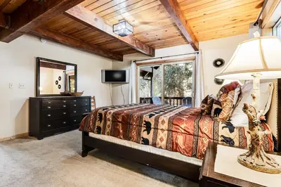 a bedroom with a bed and a mirror at Majestic Mountain in Dorrington