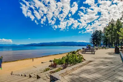 a view of a beach with people sitting on benches at Overlook Nook in Stateline